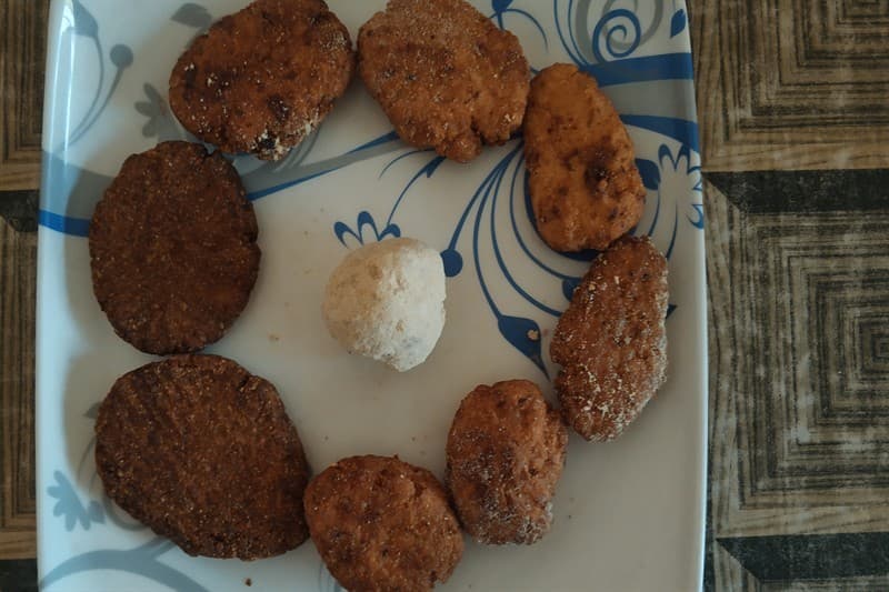 Crispy golden Bihari Thekua cookies stamped with traditional wooden molds